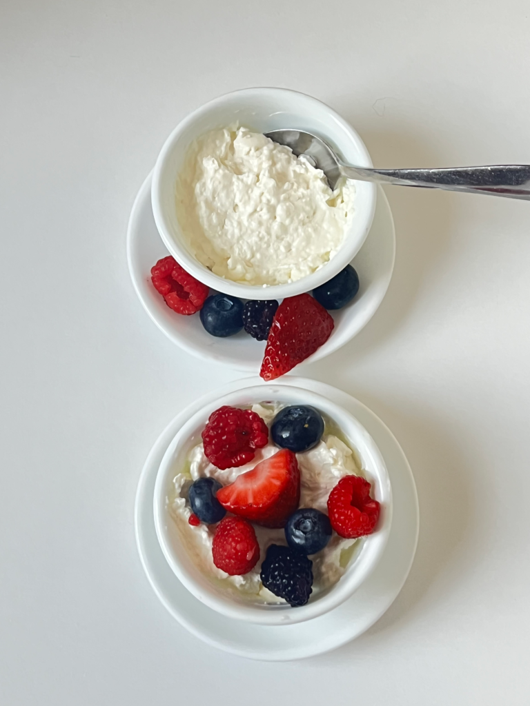 Creamy whipped cream cheese dessert in a bowl with a spoon