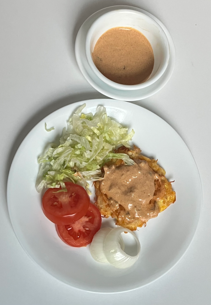 Keto Big Mac Chicken Patty topped with homemade mac sauce, served with shredded lettuce and ranch