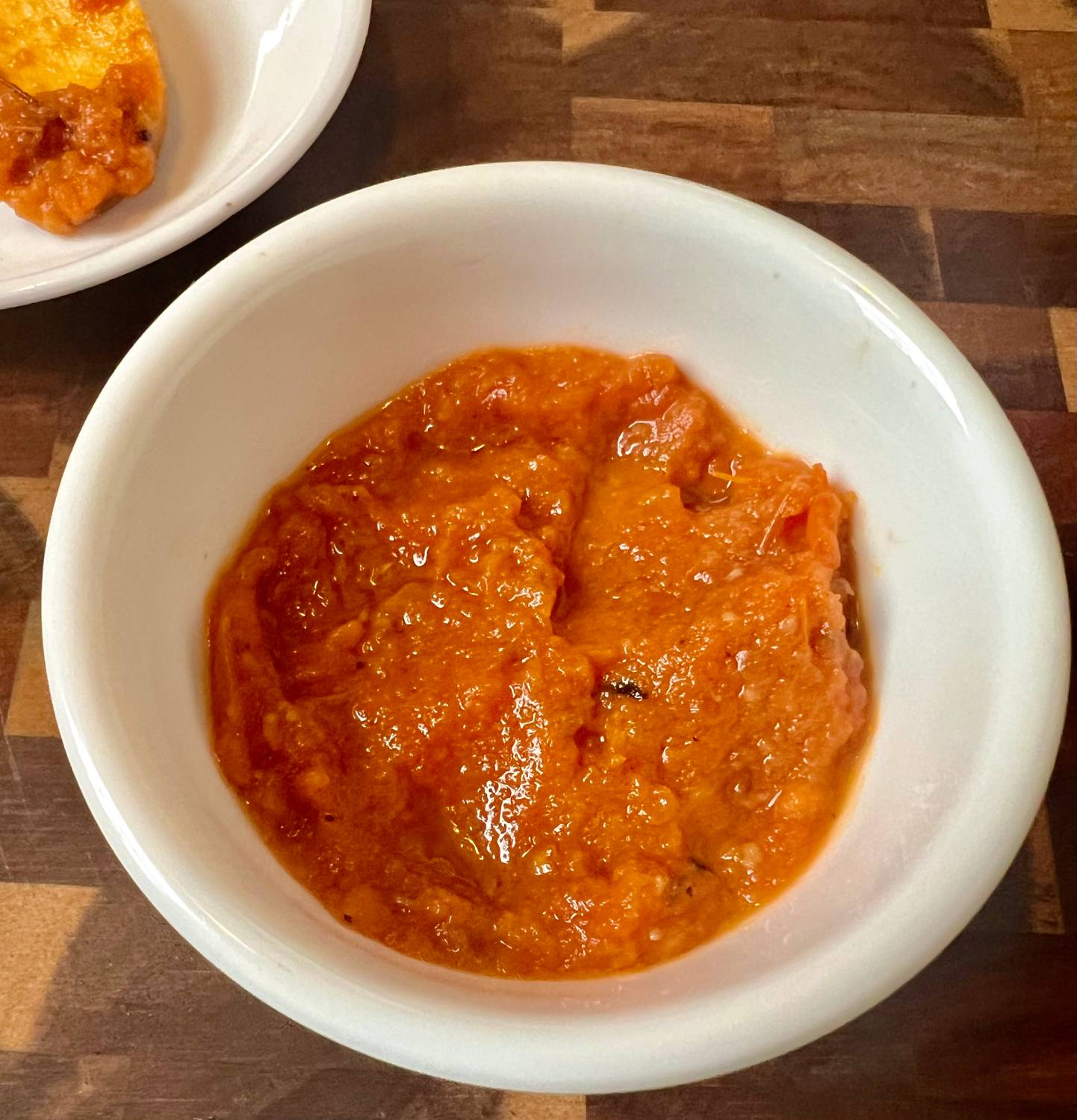 Homemade roasted tomato pasta sauce in a white bowl