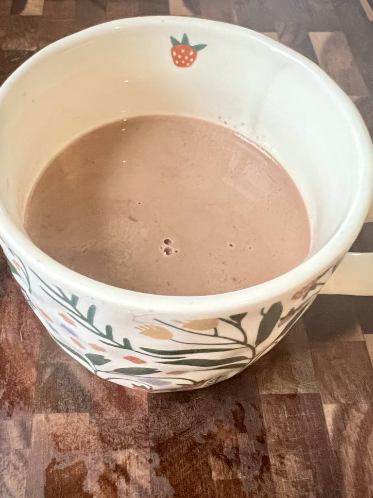 Homemade keto hot chocolate in a ceramic mug made with almond milk and sugar-free chocolate
