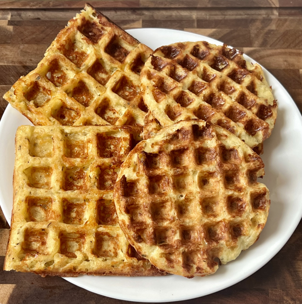 Keto chaffle cooked until golden and crispy on a white plate