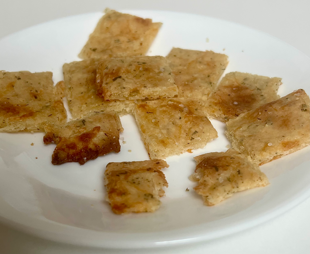 Keto almond crackers made with mozzarella and almond flour on a white plate