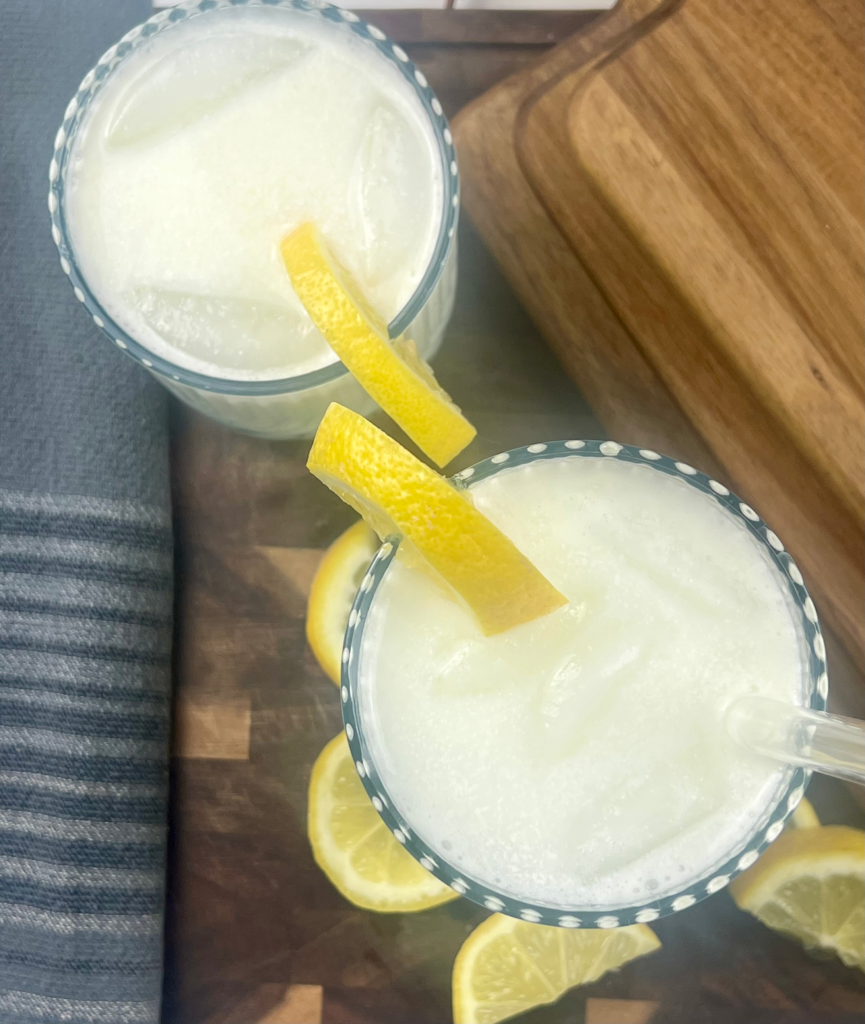 Top view of creamy keto lemonade with lemon slices and a straw