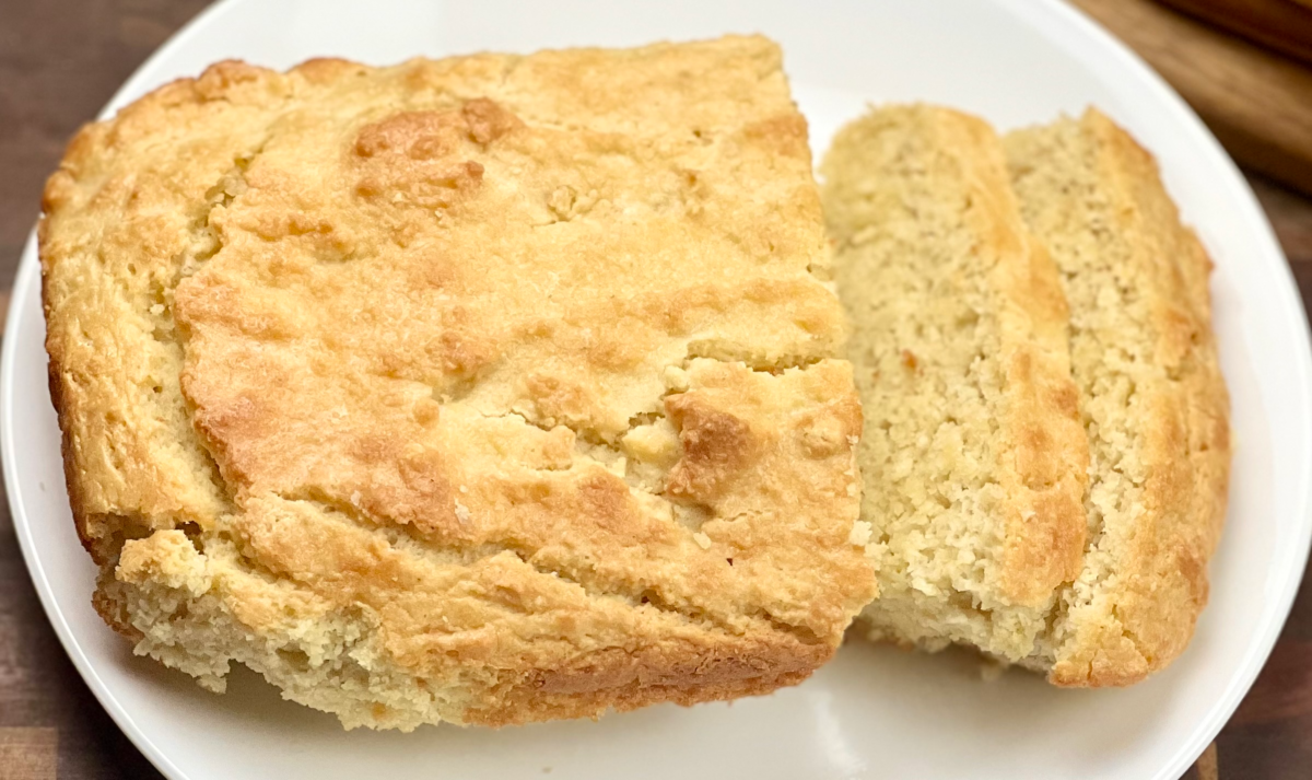 Keto almond flour bread loaf on a wooden cutting board