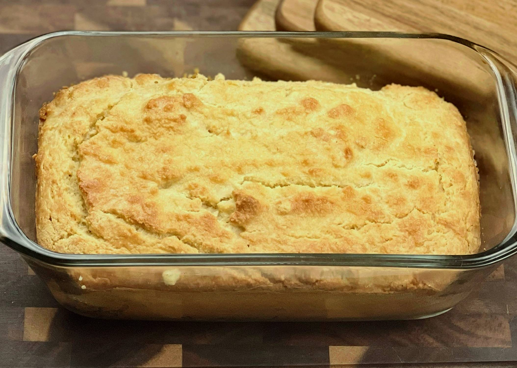 Keto almond flour bread baked in a glass loaf pan with a golden crust