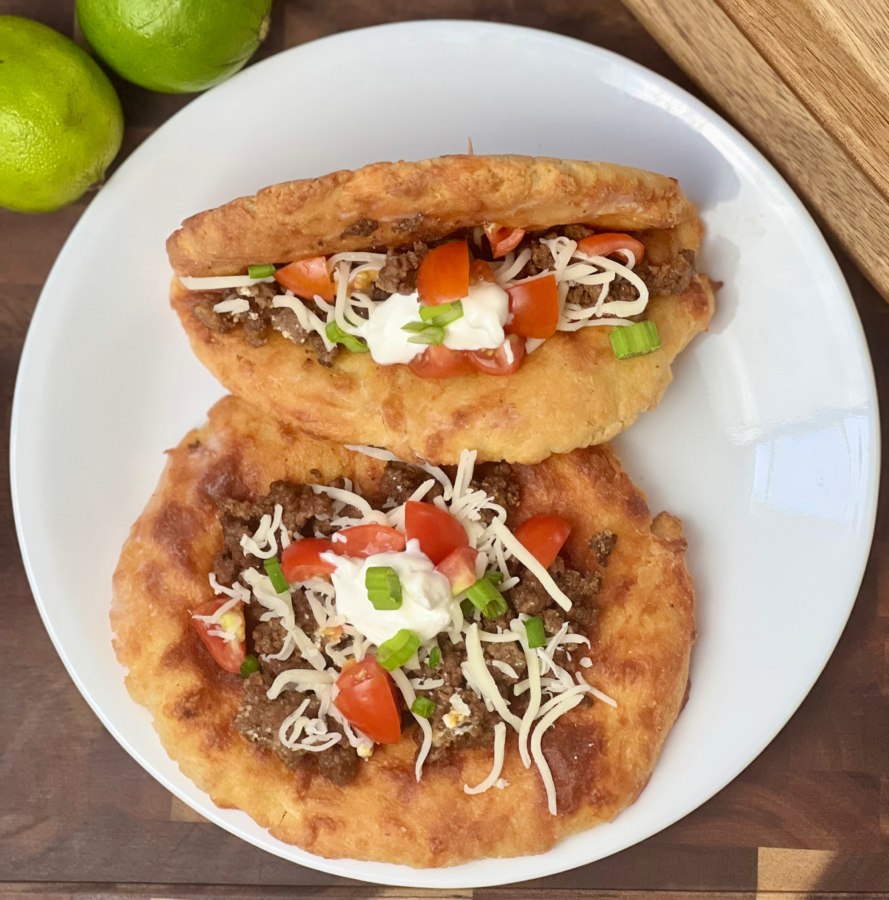 Low carb beef chalupa folded and filled with taco meat on cutting board